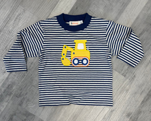 Load image into Gallery viewer, A toddler's long-sleeve striped shirt with navy and white horizontal stripes, featuring a yellow construction excavator graphic on the chest, laid flat on a gray wood floor.
